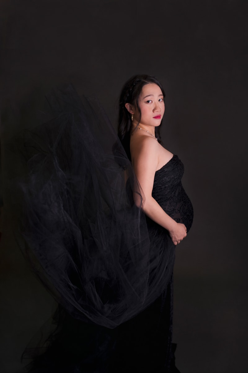 Maternity Photography, pregnant woman wears elegant dress, the train floats up