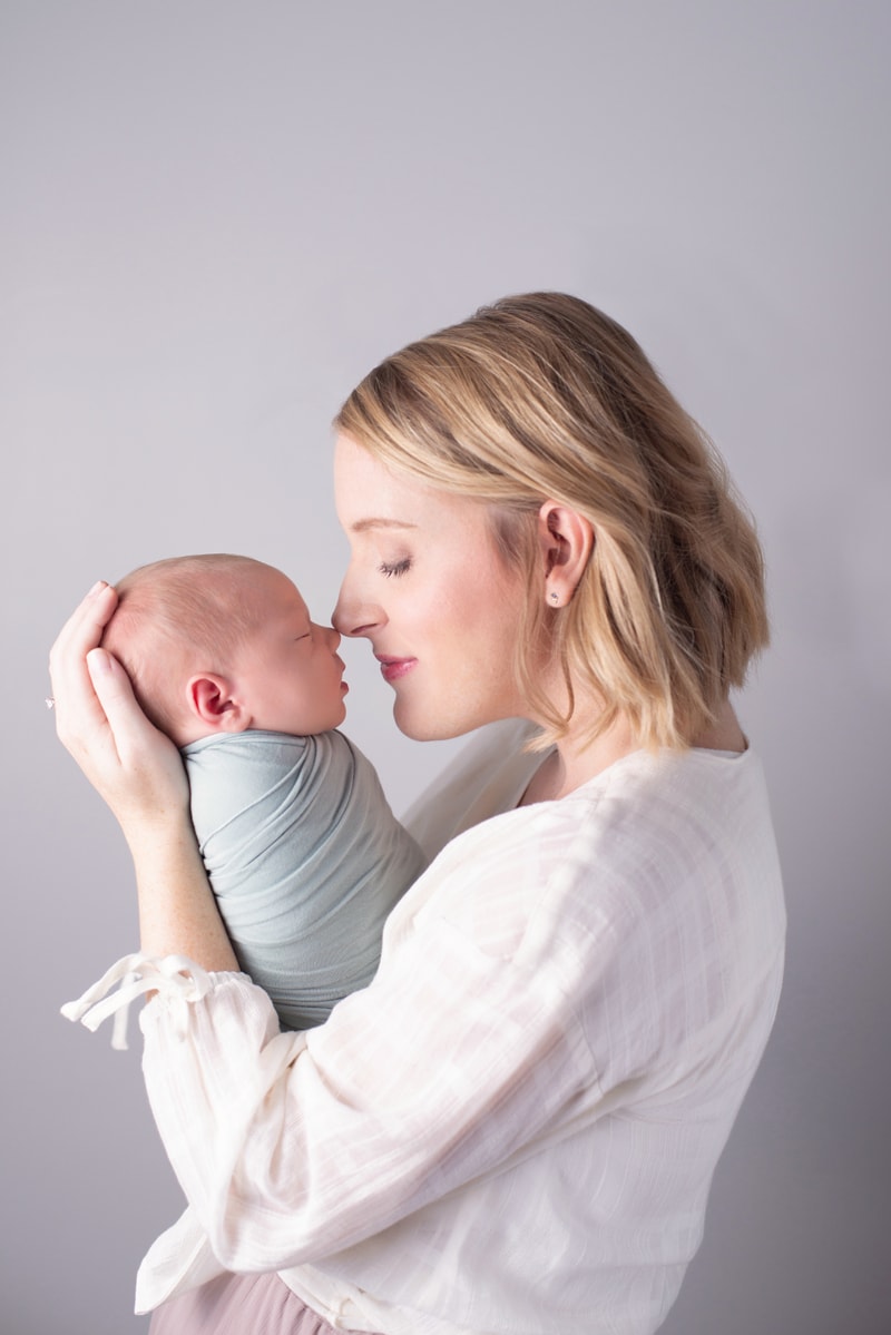 Newborn Photography, mom leans into her little baby nose to nose