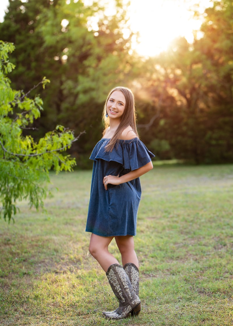 Senior photography, teen girl stands happy in the forest