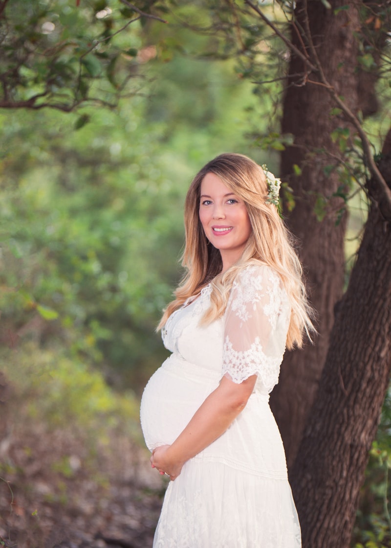 Maternity Photography, pregnant woman stands in forest