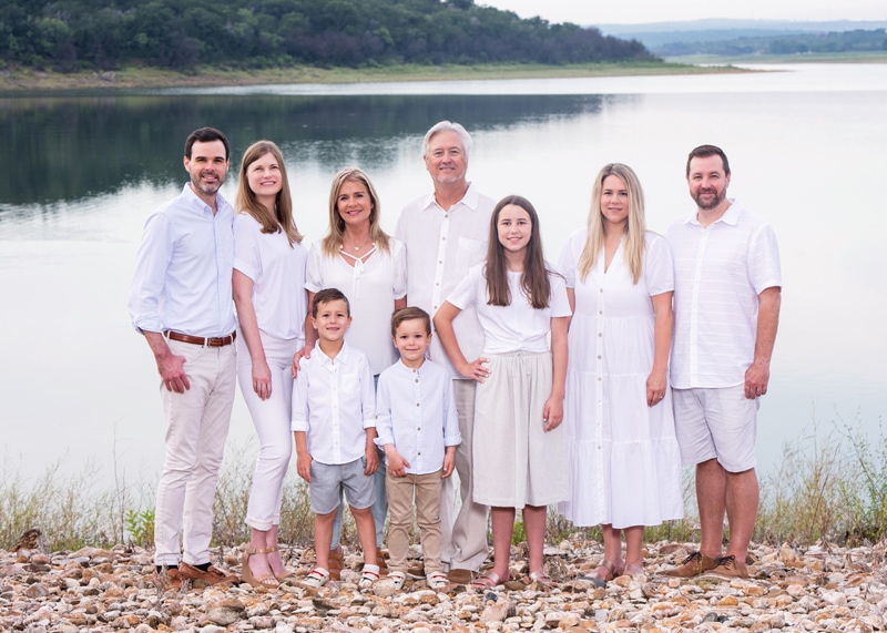 Family Photographer, a family stands near the lake, grandparents, parents, and grandchildren all together