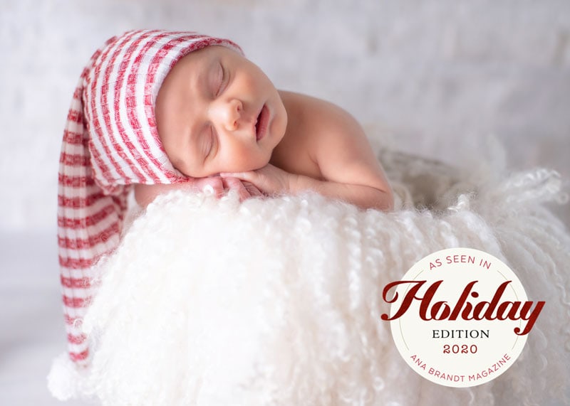 Newborn Photographer, baby lays sleeping on fluffy pillow with knit cap on head