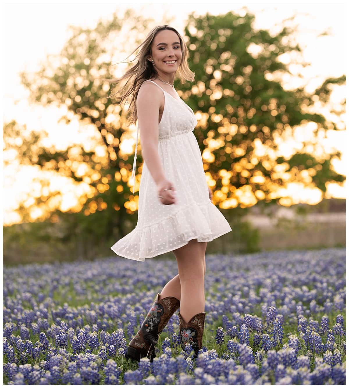 student twirls in bluebonnet field by Austin Senior Photographer
