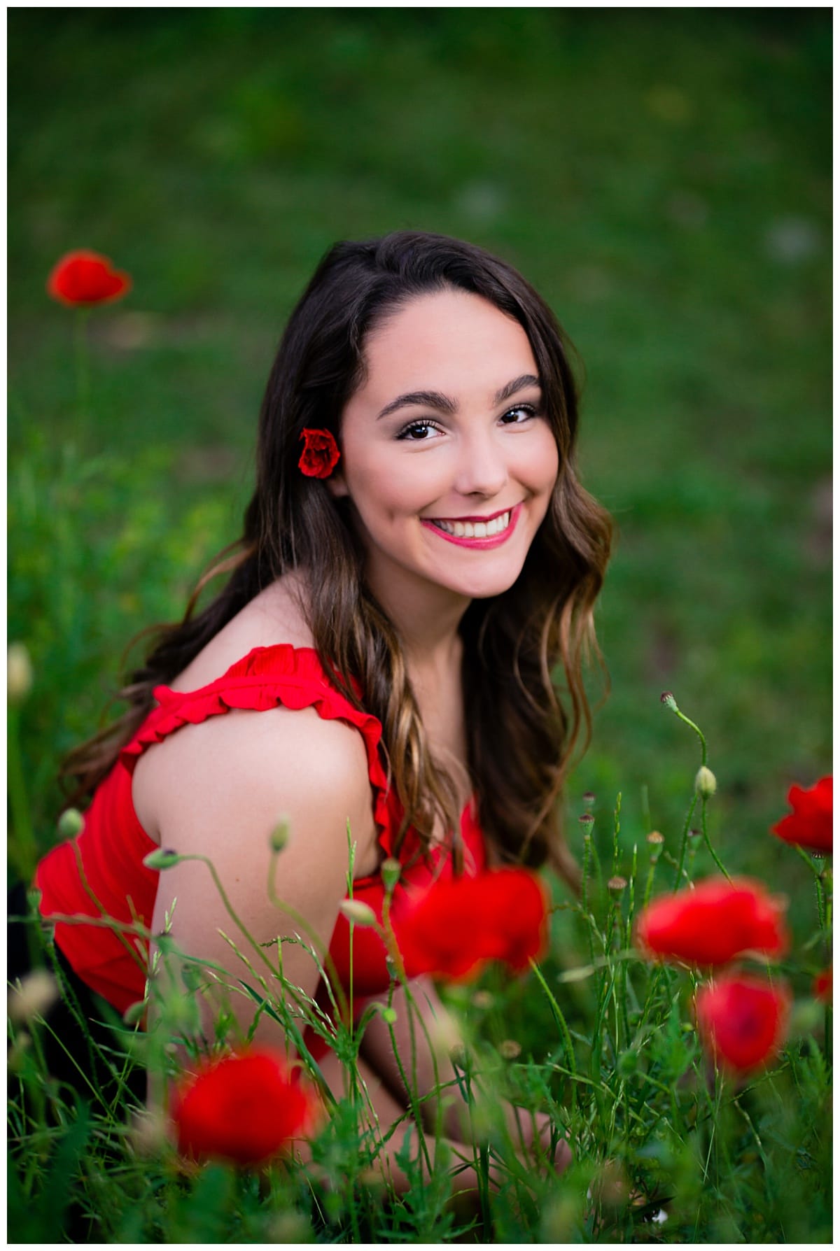 girl sits by red poppies for Downtown Georgetown + Spring Wildflower Session